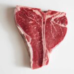 Beef Shock: Tyson Shutters Plants Raw T-bone steak on a white background