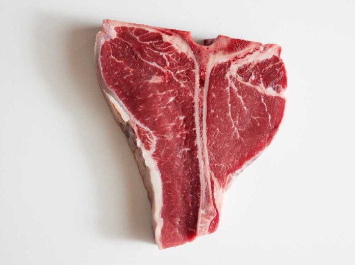 Raw T-bone steak on a white background