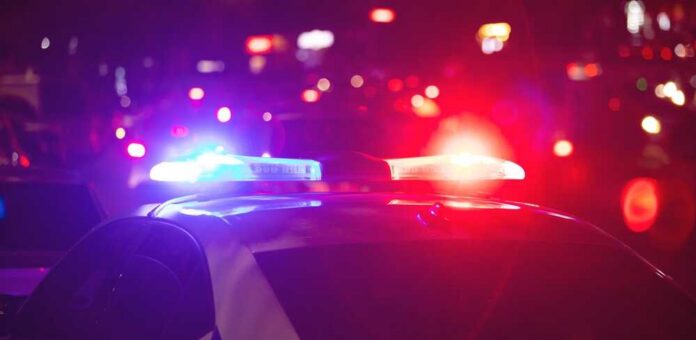 Police car with flashing red and blue lights at night