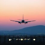 Eight Killed On Final Approach — What Went Wrong? An airplane approaching for landing against a colorful sunset sky