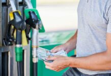$4 Gas Shock Slams Confidence Man holding cash at a gas station