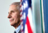 Inside Fauci’s January Jitters Anthony Fauci close-up with flag.