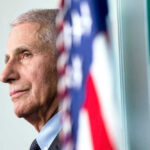 Anthony Fauci close-up with flag.