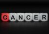 Blocks spelling the word 'CANCER' with one block in red