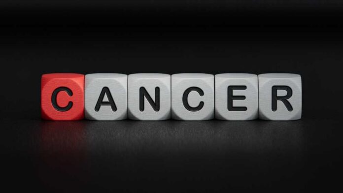 Text,Cancer,On,Wooden,Cubes.,Square,Wood,Blocks.,Top,View, Blocks spelling the word 'CANCER' with one block in red