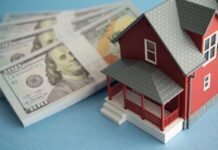Cash Kings Hijack Housing A model red house next to stacks of hundred-dollar bills