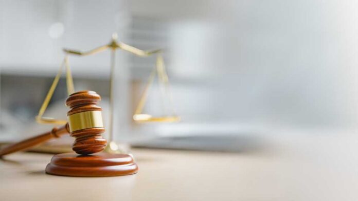 Law,Concept.,Justice,Criminal,Legal.,Hammer,Judge.,Lawyer,Judgment,Gavel. A wooden gavel and scales of justice on a desk