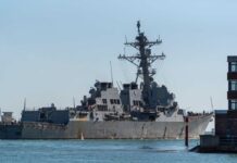 VIDEO: War At Sea? U.S. Escalates Cartel Hunt Naval destroyer sailing near a harbor with buildings in view
