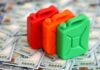 BOMBSHELL: Fuel Heist Alleged — Millions Frozen Three colorful plastic containers on a background of hundred dollar bills