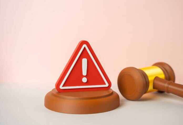 Judicial,Warning.,Restrictive,Law,,New,Rules.,Symbol,Of,Tighter,Regulation A red warning sign next to a legal gavel on a light background