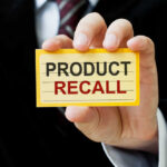 Hand holding a product recall card