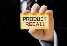 Safety Meltdown In Back Seat Hand holding a product recall card