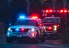 Robbery Crew Zeroes In Famed Woman Athlete Police car and ambulance with flashing lights nighttime