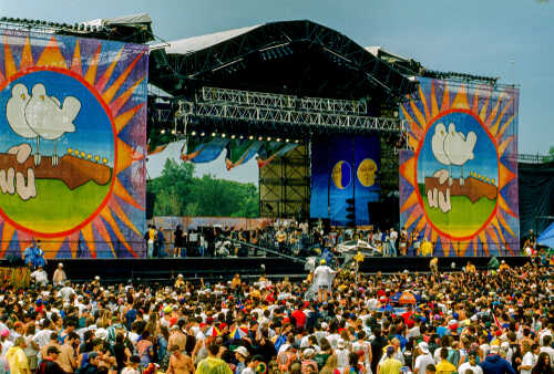 Saugerties,,New,York,,Usa,,August,12,,1994.,Crowd,In,Front A large crowd at an outdoor music festival with a vibrant stage