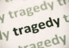 Close-up of the word 'tragedy' printed multiple times in varying shades
