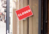 HUGE! Trump Admin Shuts THESE Schools! A red 'CLOSED' sign hanging on a storefront door