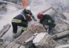 Rescue workers search rubble at a disaster site