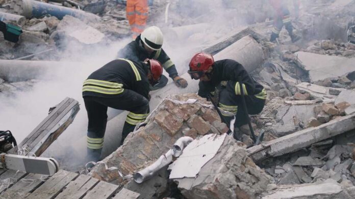 Emergency,Workers,Removing,Rubble,Together Rescue workers search rubble at a disaster site