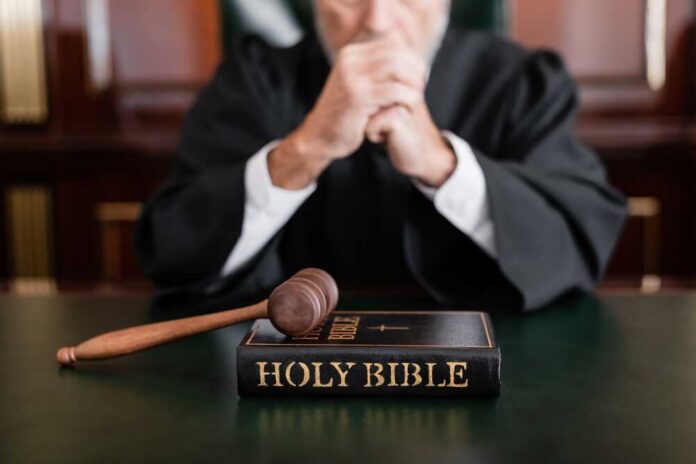 Selective,Focus,Of,Bible,And,Gavel,Near,Cropped,Judge,On A judge in a courtroom with a gavel and a Holy Bible on the table