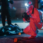 VIDEO: Nightmare Ambush Kills 12 – More Wounded Forensic investigator examines crime scene at night.