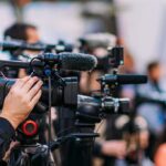 Censure Hammer Drops On Congressman Video cameras on tripods at a media event