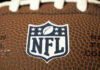 NFL Fans Stunned by Haunting Farewell Message Close-up of NFL logo on American football.