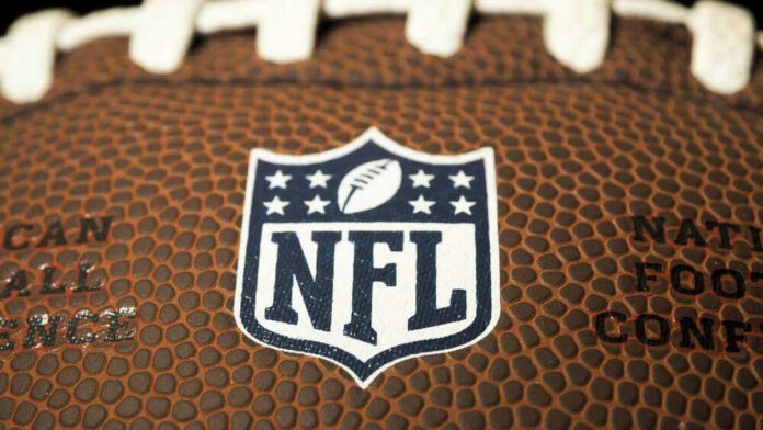 shutterstock_2268908343 Close-up of NFL logo on American football.
