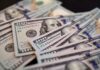 Close-up of scattered hundred dollar bills