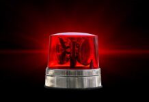 ALERT ISSUED: Expect Sudden Air Chaos Red emergency beacon light on a dark background