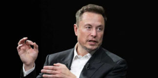 Elon Musk in a suit talking.