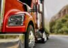 Hands-Free Towing Hits America’s Top Truck Close-up of a red truck on a road with a mountainous background