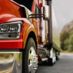 Hands-Free Towing Hits America’s Top Truck Close-up of a red truck on a road with a mountainous background