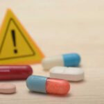 NEW: Fat-Burn Pill Stuns Scientists Pills with warning sign in background