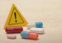 NEW: Fat-Burn Pill Stuns Scientists Pills with warning sign in background