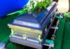 Beloved TV Star Gone at 75 A silver casket adorned with flowers at a gravesite