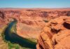 Grim Find Halts Canyon Hunt Colorado River winding through a red rock canyon under a clear blue sky