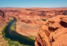 Colorado River winding through a red rock canyon under a clear blue sky