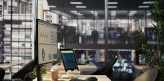 Computer monitor with analytics dashboard in a modern open office