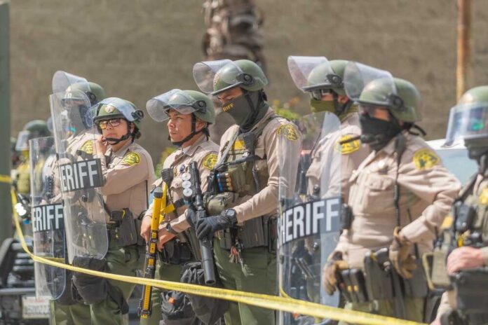 Los,Angeles,,California,,Usa,,July,14,,2025,,Police,On,Standby Dontrelle Inman and Danny White among sheriff deputies in riot gear holding shields