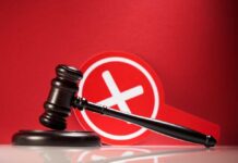Bombshell Hits West Wing – Judge Says STOP! Judge's gavel with a red cross symbol in the background