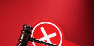 Judge's gavel with a red cross symbol in the background