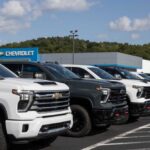 V8 Comeback: Silverado Drops A Bomb Row of pickup trucks at a dealership lot