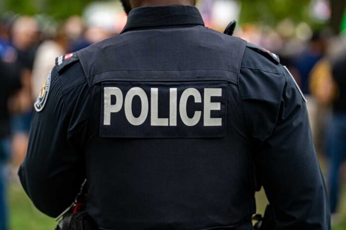 Back,View,Of,Police,Uniform,With,Label. Back view of a police officer wearing a uniform with 'POLICE' displayed