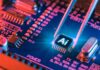 AI Toothbrush Films Inside Mouth? WHAT? AI microchip on a blue circuit board held by tweezers