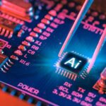 AI microchip on a blue circuit board held by tweezers