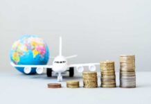 Holiday Flights STING – Prices Explode Stacked coins in front of a toy airplane and globe