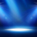 Empty stage with blue spotlights shining down.