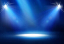 Empty stage with blue spotlights shining down.