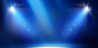 Empty stage with blue spotlights shining down.