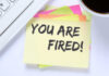 U.S. Food Company Axes Staff, Shuts Plants A sticky note with the message 'YOU ARE FIRED!' placed on a desk next to a keyboard and a cup of coffee